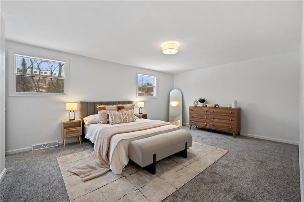 200 Pinchtown Road Pittsburgh, PA 15236 - Photo 14 of 26 a spacious bedroom with a bed and a lamp