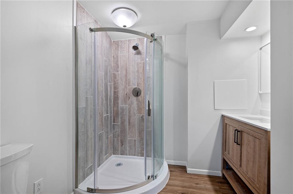 200 Pinchtown Road Pittsburgh, PA 15236 - Photo 21 of 26 a bathroom with a granite countertop sink a toilet and shower