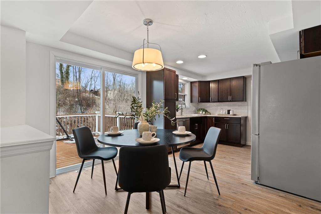 200 Pinchtown Road Pittsburgh, PA 15236 - Photo 5 of 26 a view of a dining room with furniture wooden floor and chandelier