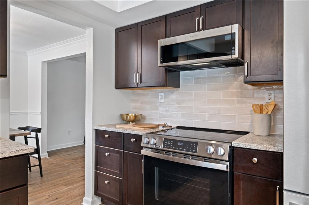 200 Pinchtown Road Pittsburgh, PA 15236 - Photo 7 of 26 a kitchen with stainless steel appliances a stove a microwave and sink