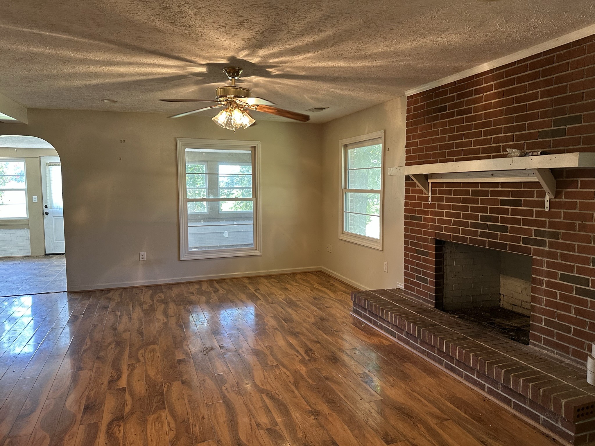10026 Mona Road Murfreesboro, TN 37129 - Photo 49 of 64 a view of an empty room with wooden floor fireplace and a window