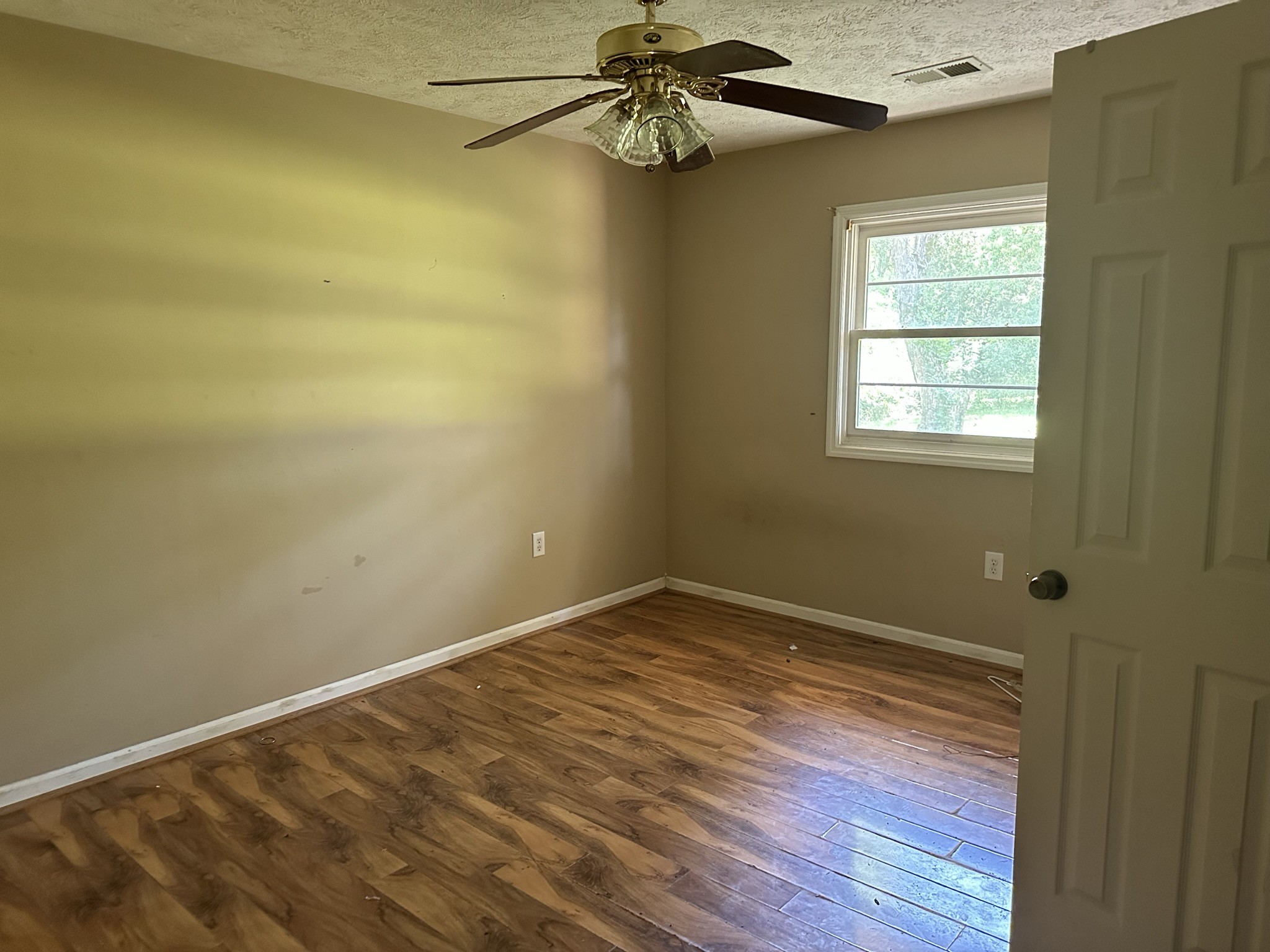 10026 Mona Road Murfreesboro, TN 37129 - Photo 58 of 64 a view of an empty room with wooden floor and a window