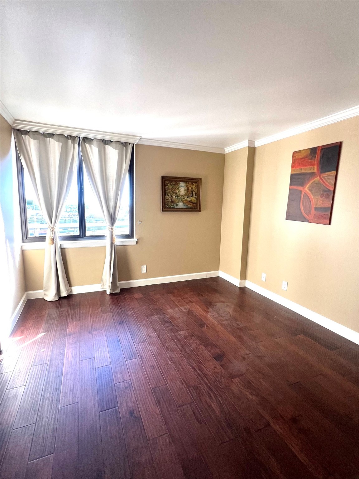 3525 Sage Road, Unit 1218 Houston, TX 77056 - Photo 6 of 18 an empty room with wooden floor and windows