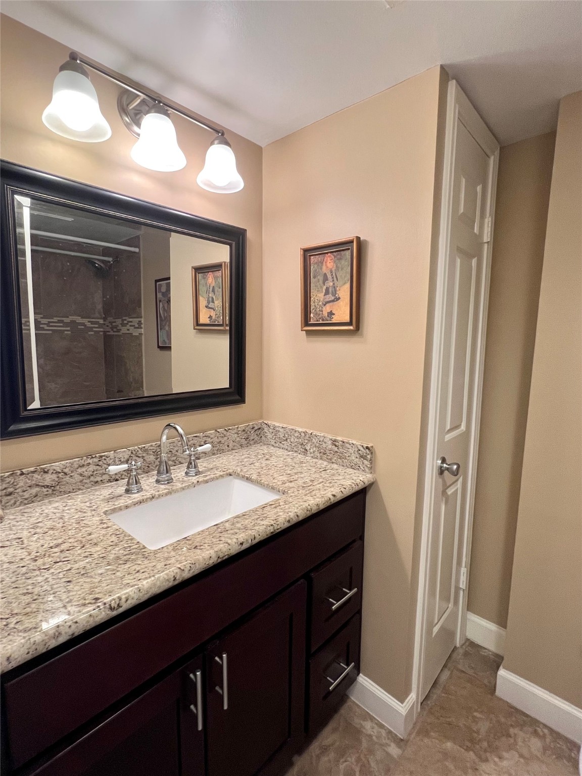 3525 Sage Road, Unit 1218 Houston, TX 77056 - Photo 9 of 18 a bathroom with a granite countertop sink vanity and mirror