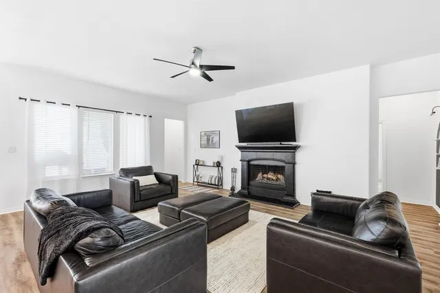 a living room with furniture a fireplace and a flat screen tv