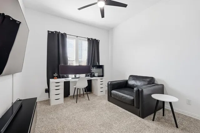 a living room with furniture a lamp and a flat screen tv