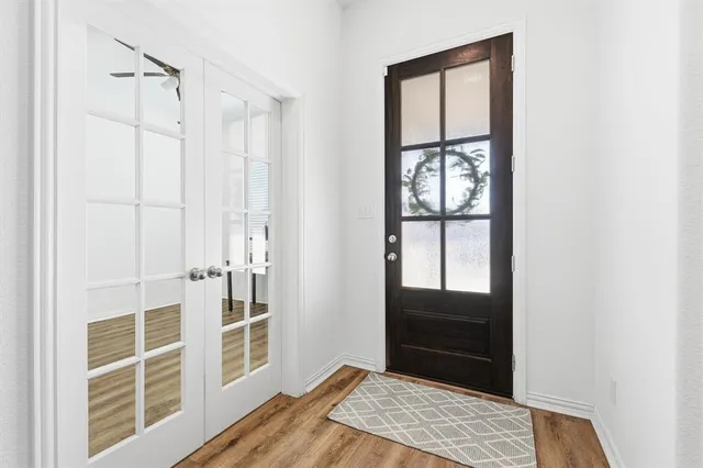 a view of a bedroom with wooden floor and closet