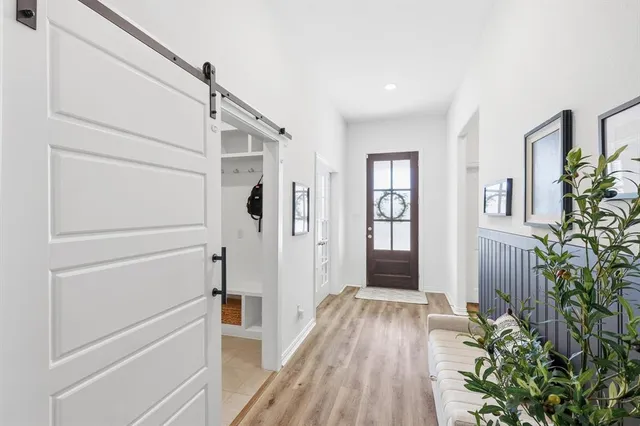a view of hallway with wooden floor and stairs