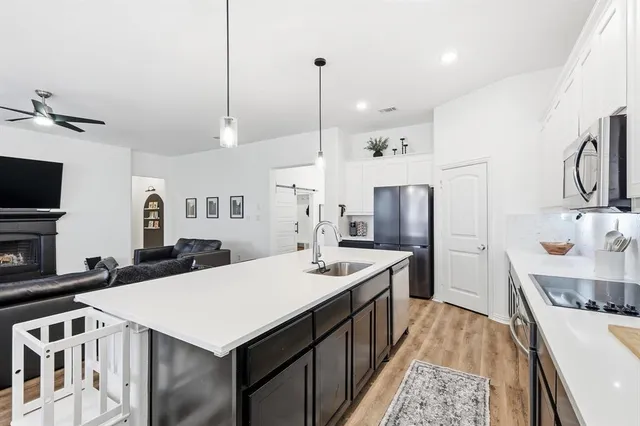 a kitchen with a sink a stove a refrigerator and a oven