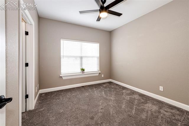 711 Pine Ridge Street Elizabeth, CO 80107 - Photo 31 of 39 Empty room featuring ceiling fan and dark carpet