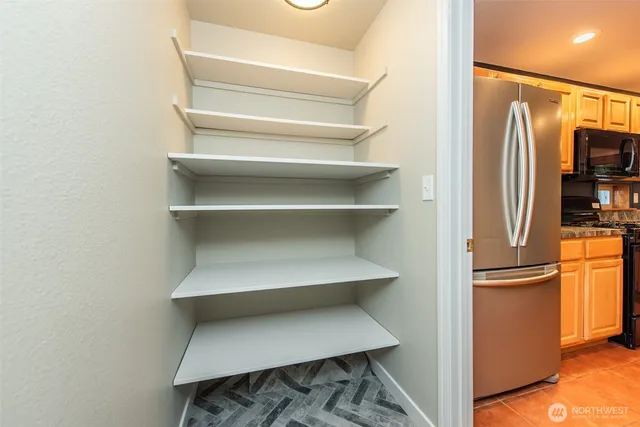 a view of walk in closet with empty racks