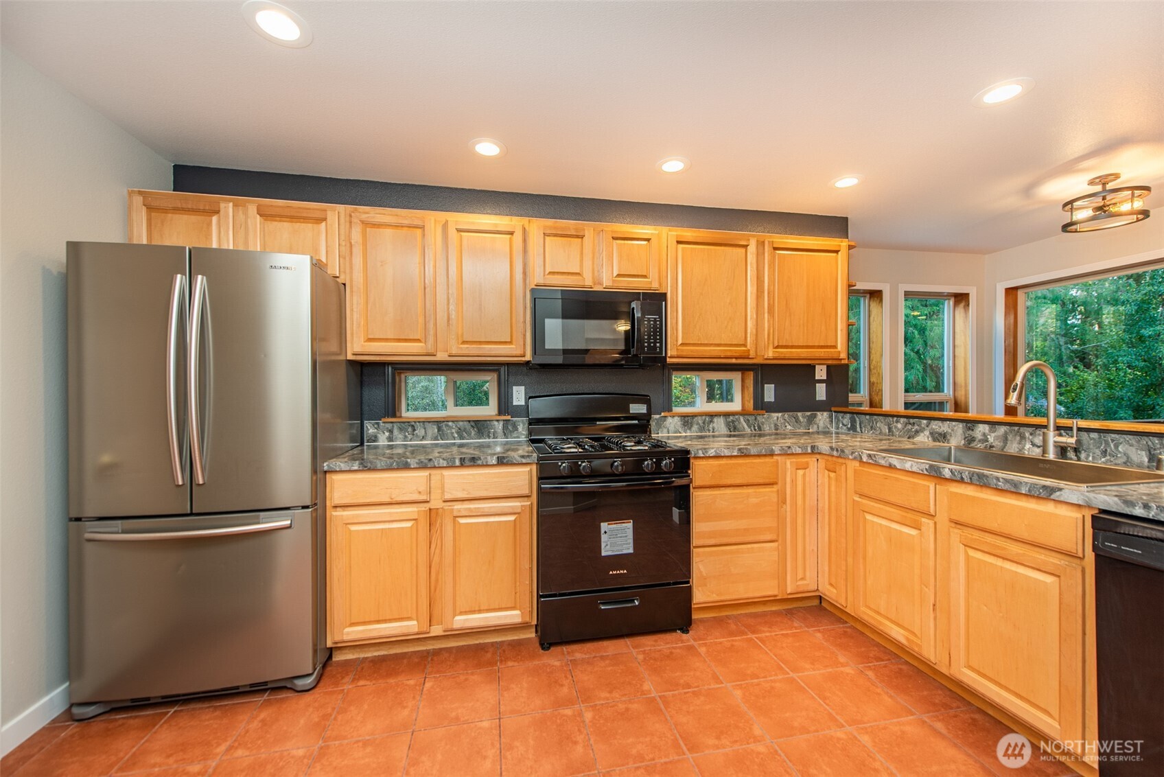 62 Pierson Lane Sequim, WA 98382 - Photo 13 of 40 a kitchen with stainless steel appliances granite countertop a refrigerator and a stove top oven