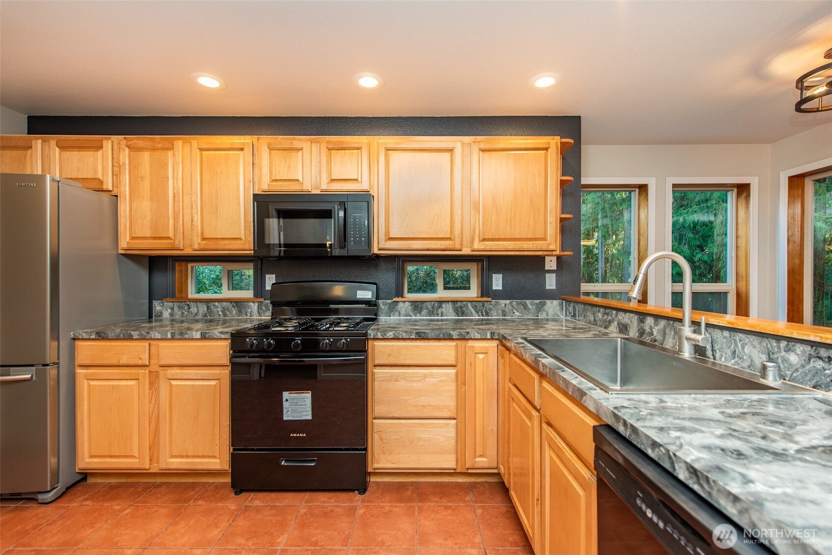 62 Pierson Lane Sequim, WA 98382 - Photo 17 of 40 a kitchen with stainless steel appliances granite countertop a stove a sink and a microwave