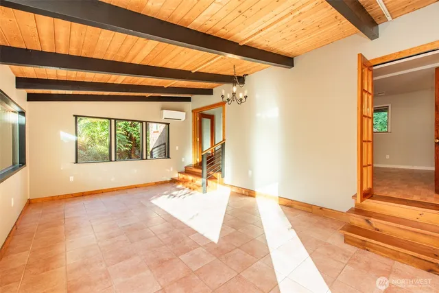 a view of a room with wooden floor and windows