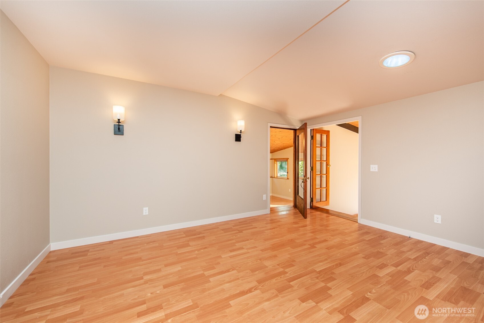 62 Pierson Lane Sequim, WA 98382 - Photo 10 of 40 a view of an empty room with wooden floor and a window