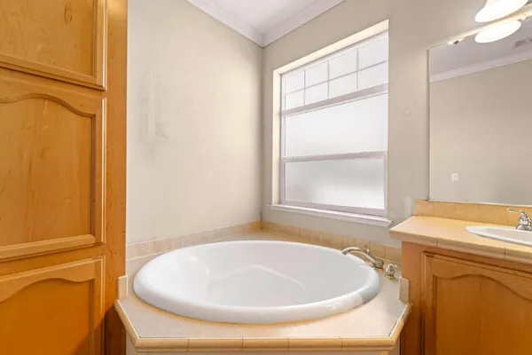 a bathroom with a bathtub and a window