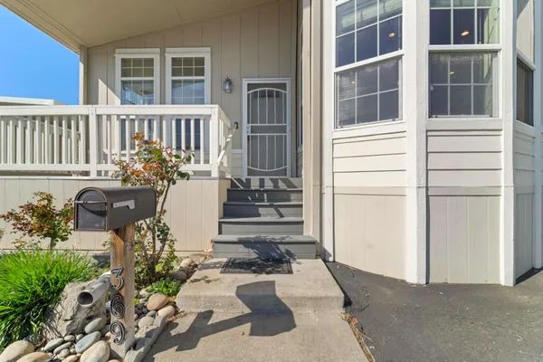 a view of a patio with couches table and chairs and potted plants