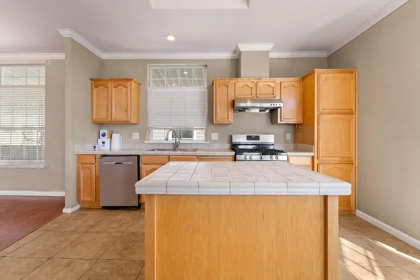 a kitchen with a sink appliances and cabinets