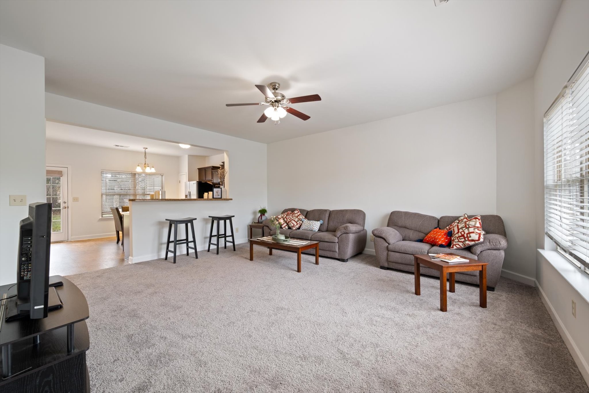 735 Tulip Grove Road, Unit 311 Hermitage, TN 37076 - Photo 4 of 23 a living room with furniture a flat screen tv and a window