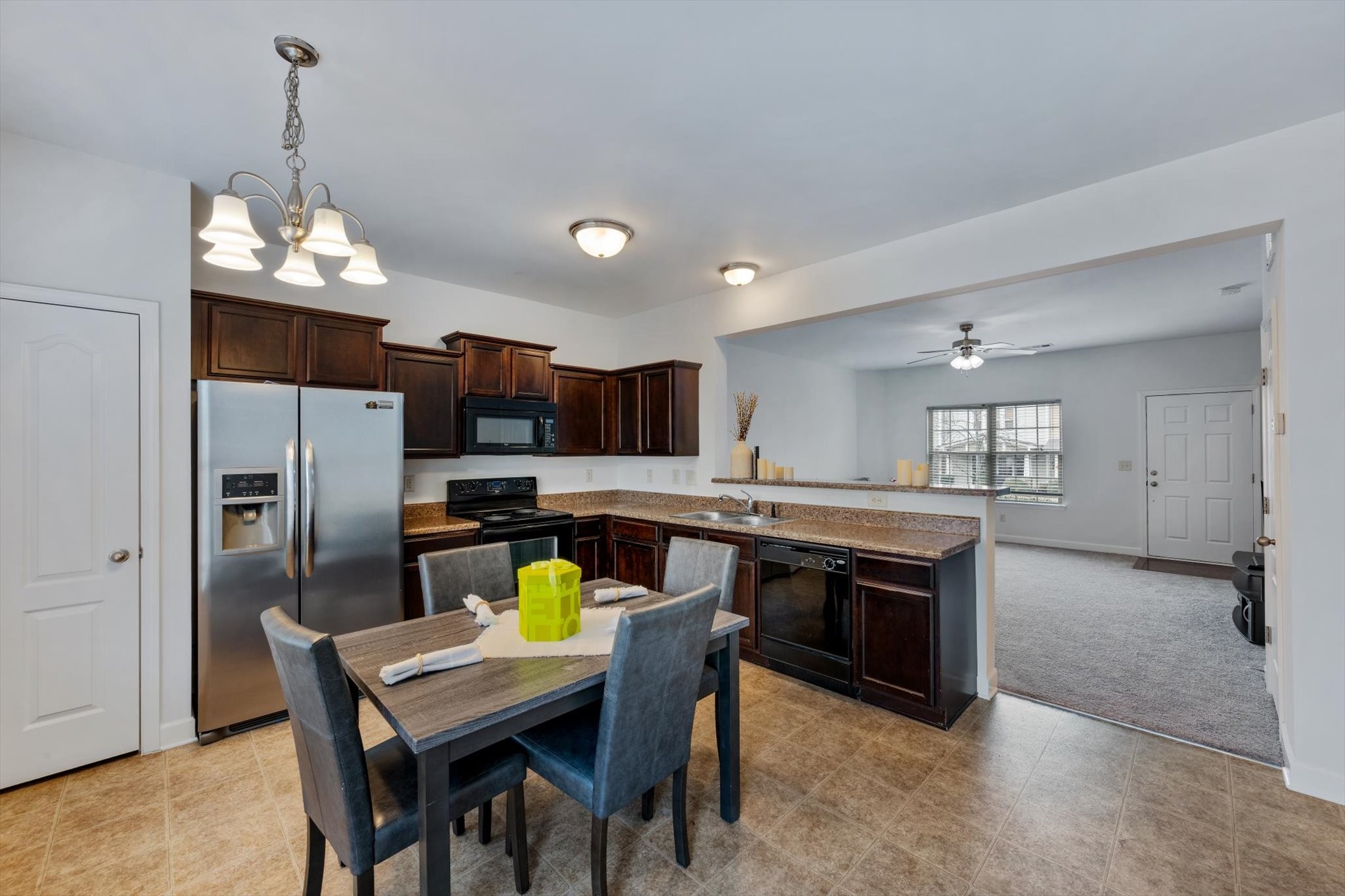735 Tulip Grove Road, Unit 311 Hermitage, TN 37076 - Photo 7 of 23 a kitchen with stainless steel appliances granite countertop a sink a stove a dining table and chairs