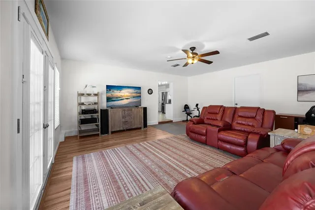 a living room with furniture and wooden floor