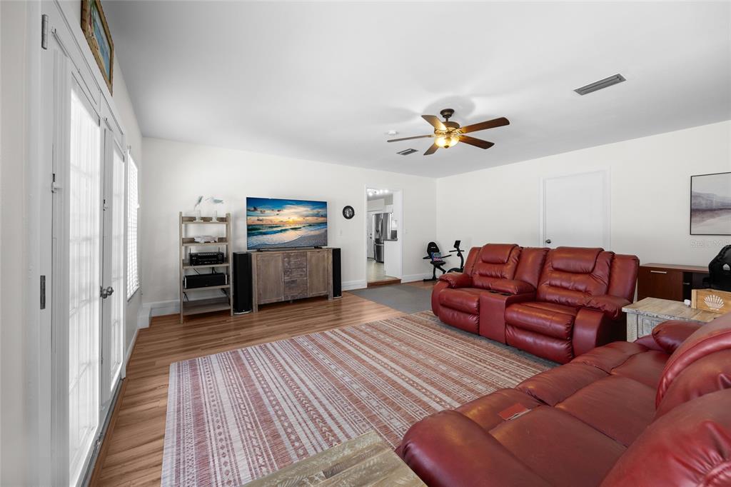 3012 Southeast Country Club Road Lake City, FL 32025 - Photo 17 of 41 a living room with furniture and wooden floor