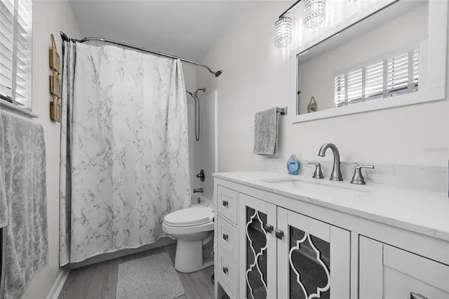 a bathroom with a sink a toilet and a shower