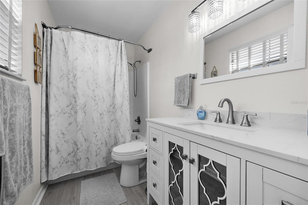 3012 Southeast Country Club Road Lake City, FL 32025 - Photo 20 of 41 a bathroom with a sink a toilet and a shower