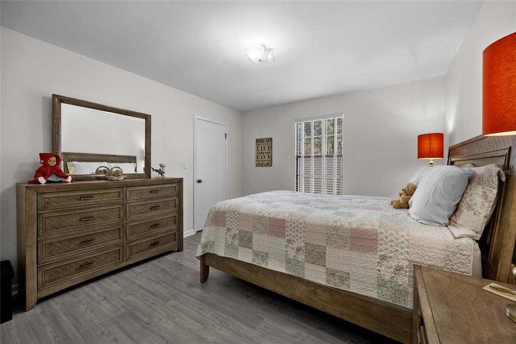 3012 Southeast Country Club Road Lake City, FL 32025 - Photo 21 of 41 a bedroom with a bed and a dresser