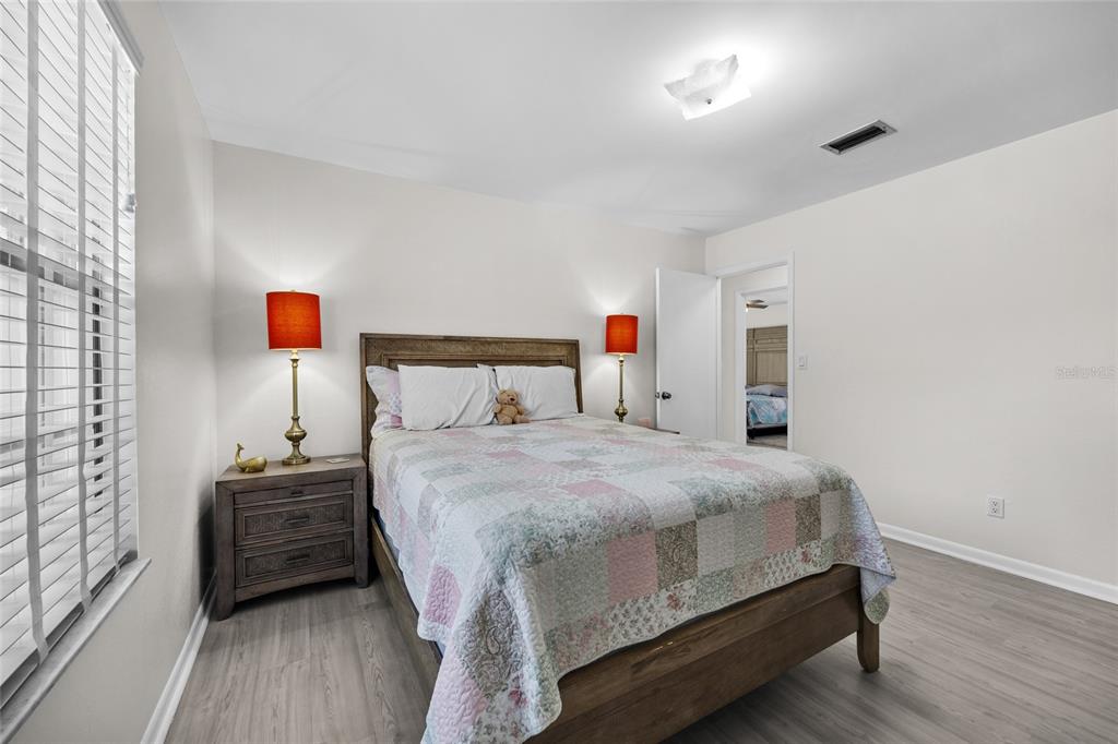 3012 Southeast Country Club Road Lake City, FL 32025 - Photo 22 of 41 a bedroom with a bed and wooden floor