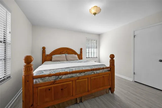 a bedroom with furniture and wooden floor