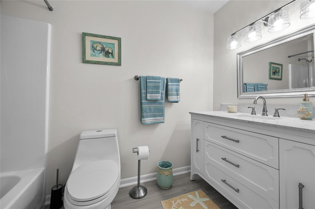 3012 Southeast Country Club Road Lake City, FL 32025 - Photo 25 of 41 a bathroom with a toilet sink and mirror