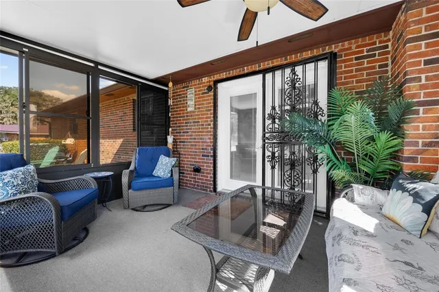 a living room with furniture and floor to ceiling windows
