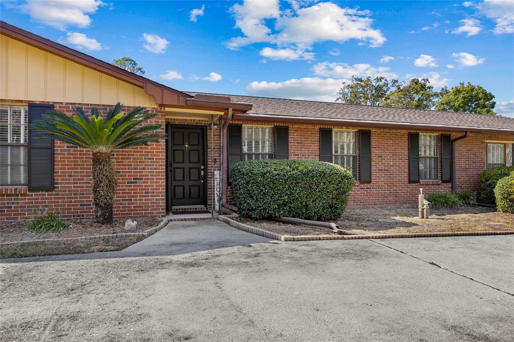 3012 Southeast Country Club Road Lake City, FL 32025 - Photo 33 of 41 a view of a house with a yard and potted plants