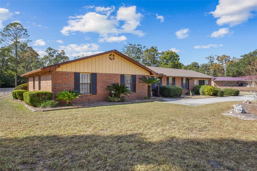 3012 Southeast Country Club Road Lake City, FL 32025 - Photo 34 of 41 a view of a house with backyard and garden