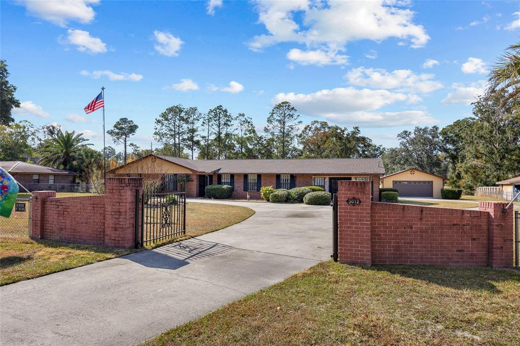 3012 Southeast Country Club Road Lake City, FL 32025 - Photo 35 of 41 a front view of a house with a yard