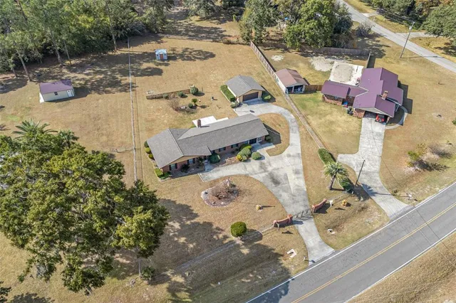 an aerial view of a house with a yard basket ball court