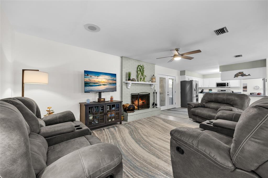 3012 Southeast Country Club Road Lake City, FL 32025 - Photo 5 of 41 a living room with furniture a fireplace and a flat screen tv