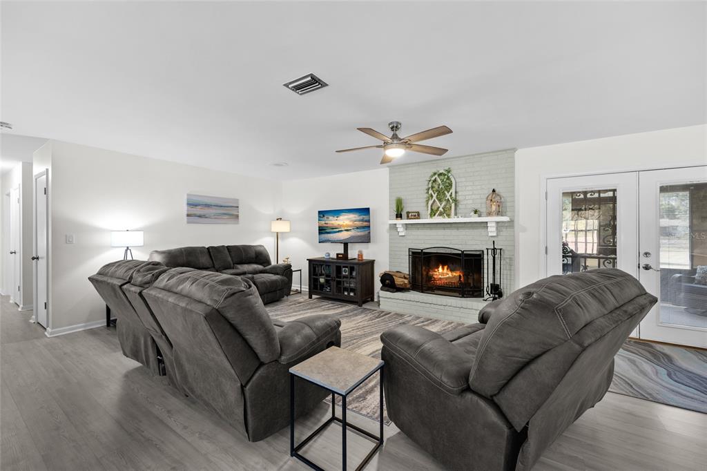 3012 Southeast Country Club Road Lake City, FL 32025 - Photo 6 of 41 a living room with furniture and a fireplace