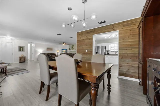 a view of a a dining room with furniture and wooden floor