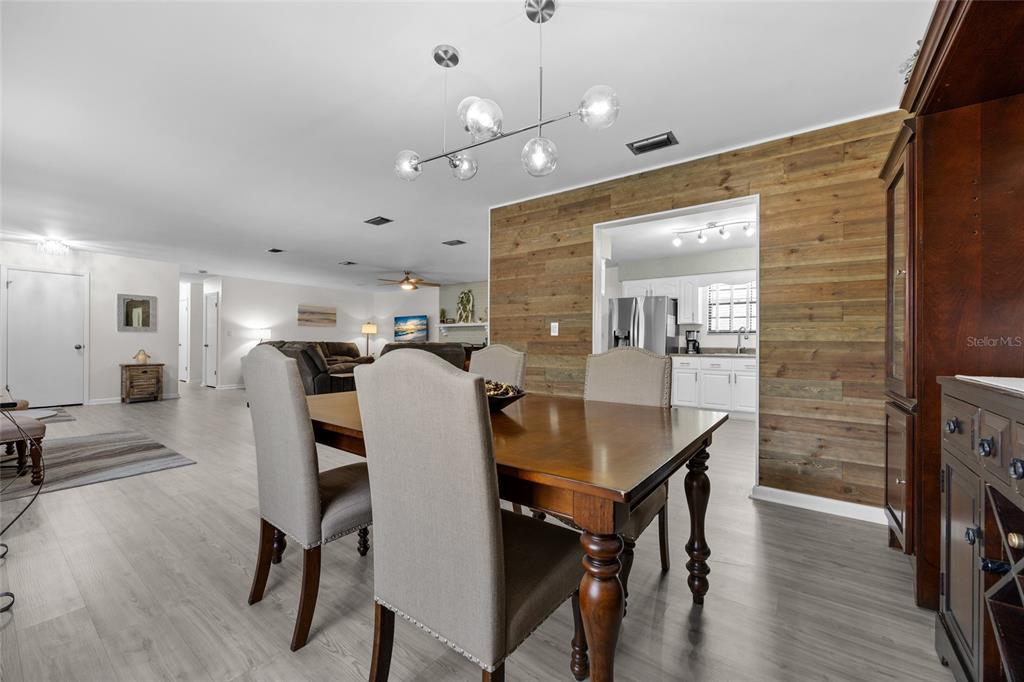 3012 Southeast Country Club Road Lake City, FL 32025 - Photo 10 of 41 a view of a a dining room with furniture and wooden floor