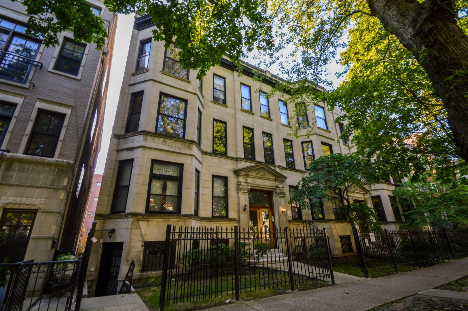 3724 North Fremont Street, Unit 2 Chicago, IL 60613 - Photo 1 of 14 a front view of a residential apartment building with a yard
