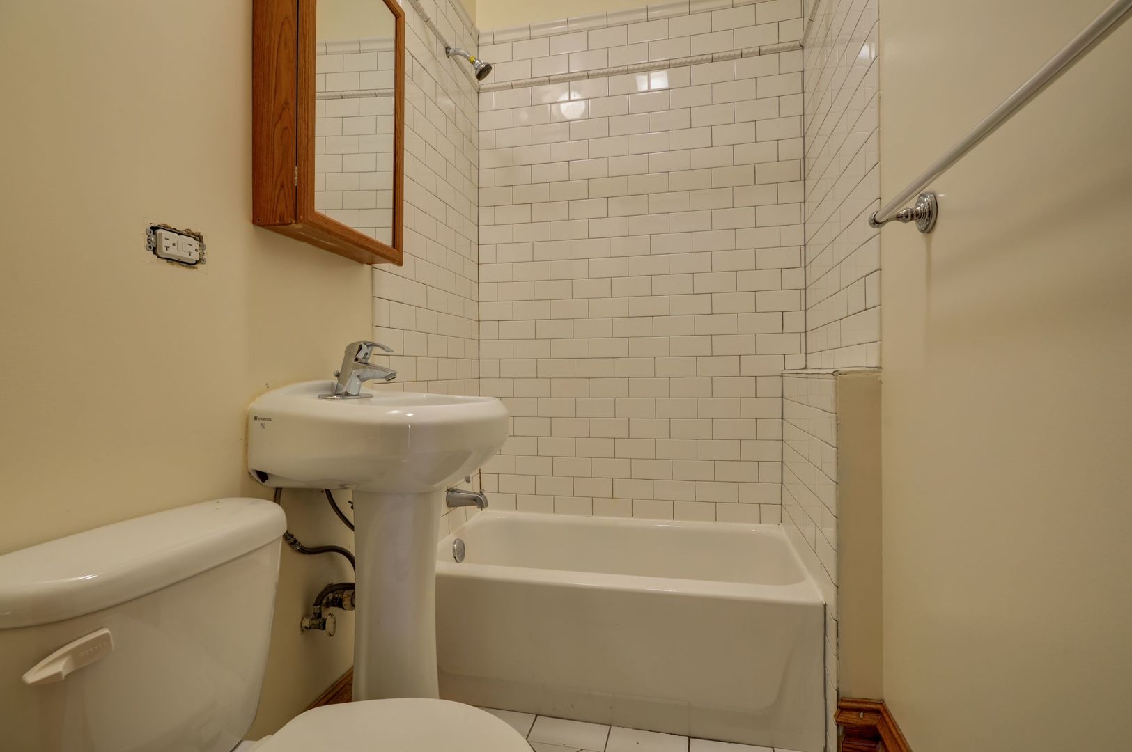 3724 North Fremont Street, Unit 2 Chicago, IL 60613 - Photo 14 of 14 a bathroom with a sink a toilet and shower