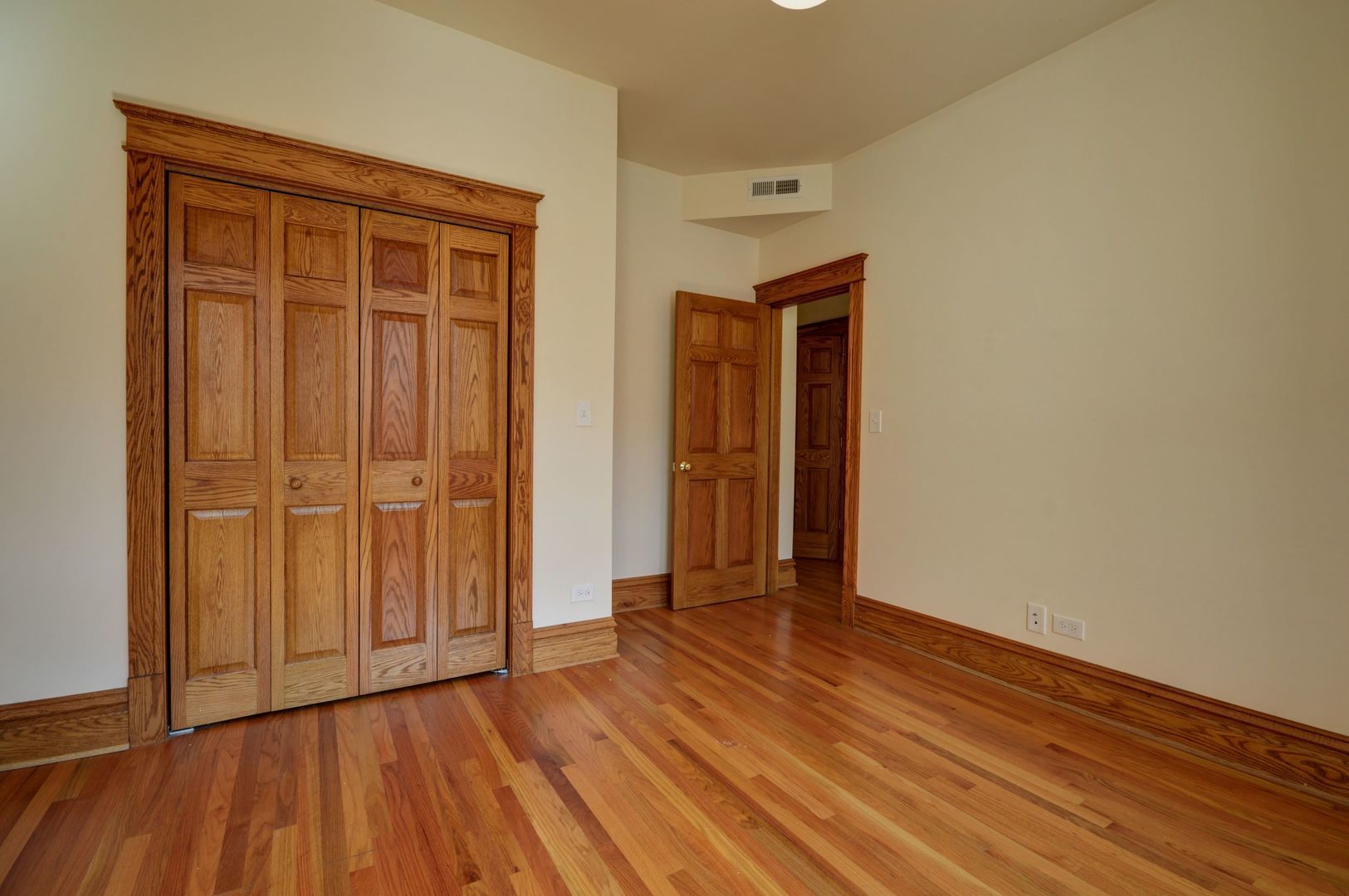 3724 North Fremont Street, Unit 2 Chicago, IL 60613 - Photo 8 of 14 a view of an empty room with wooden floor and a window
