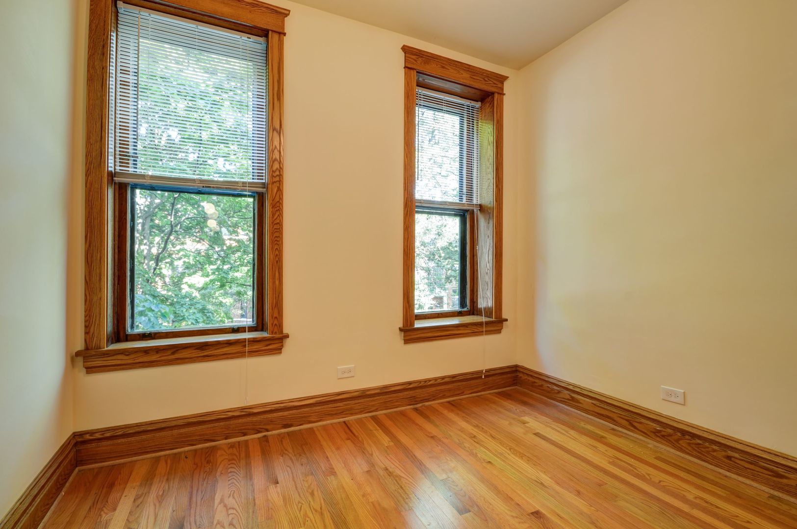 3724 North Fremont Street, Unit 2 Chicago, IL 60613 - Photo 9 of 14 a view of an empty room with wooden floor and a window