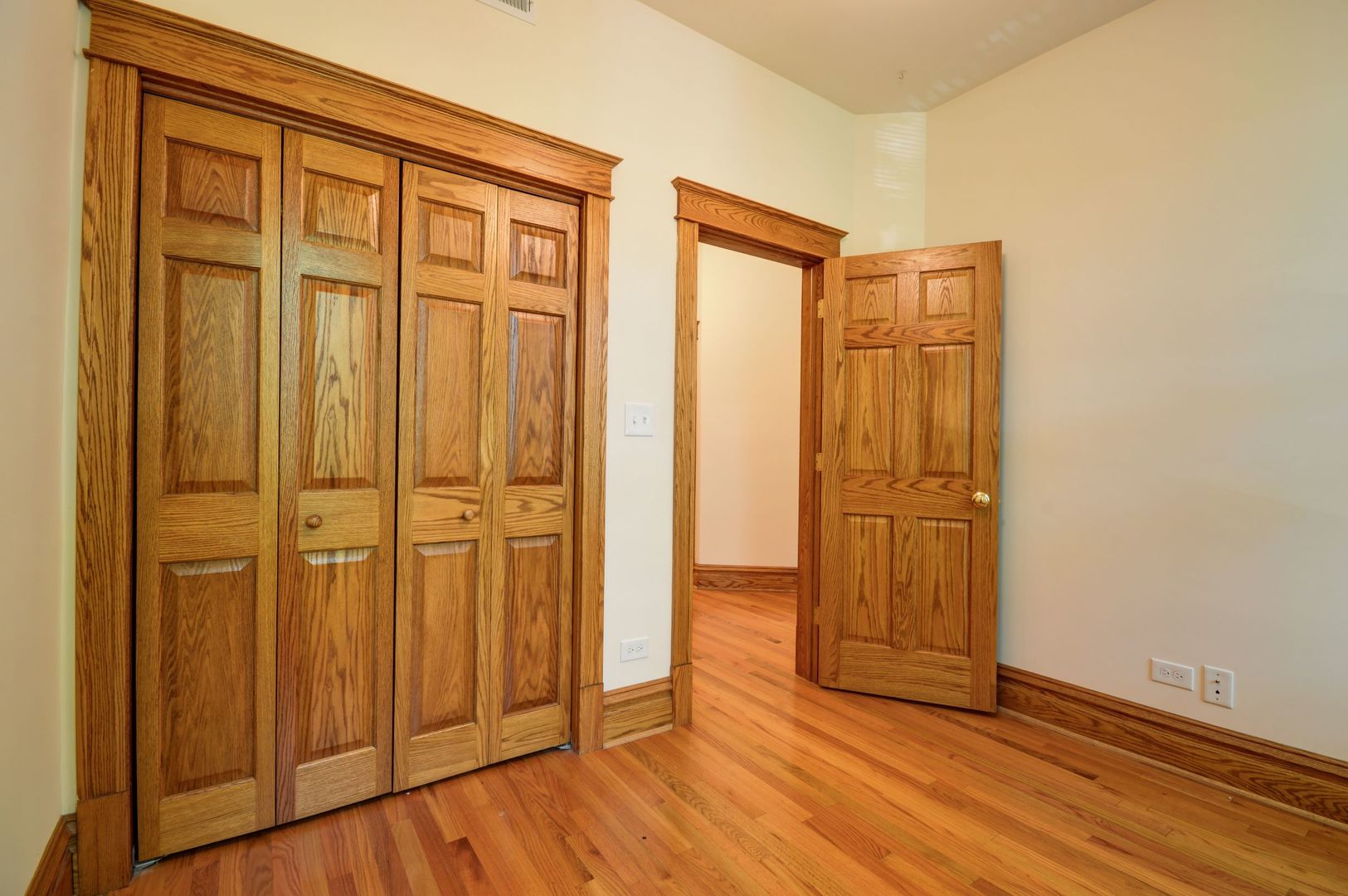 3724 North Fremont Street, Unit 2 Chicago, IL 60613 - Photo 10 of 14 an empty room with wooden floor and closet area