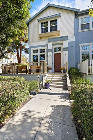 a living room with furniture a flat screen tv and a window