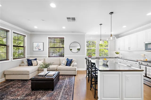 a living room with furniture a flat screen tv and a large window