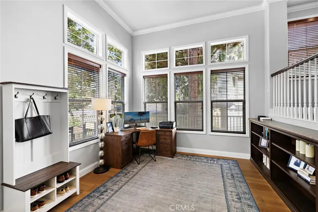 a dining room with furniture a rug and wooden floor