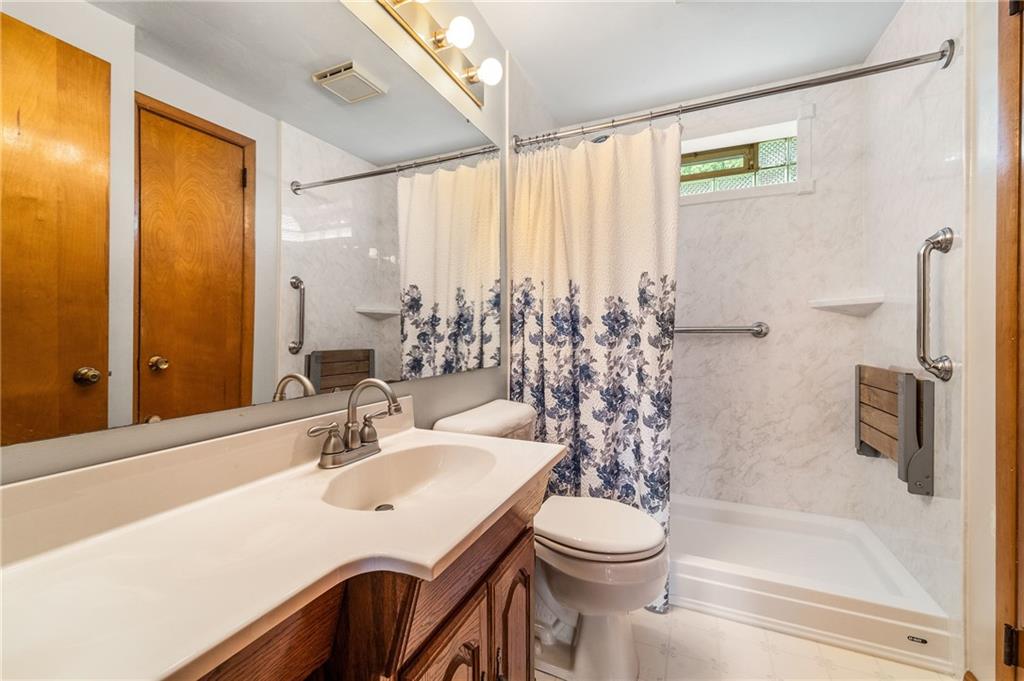 239 Roberts Road Pittsburgh, PA 15239 - Photo 12 of 30 a bathroom with a sink a toilet and shower